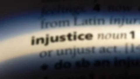 Injustice word in a dictionary. Stock Footage 99561329