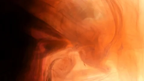 Ink being poured into water,phantom flex. Red,orange,yellow and black. Inks in w Stock Footage