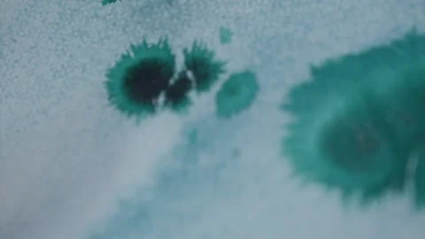 The ink from a blue marker melts onto the Stock Footage 143453311