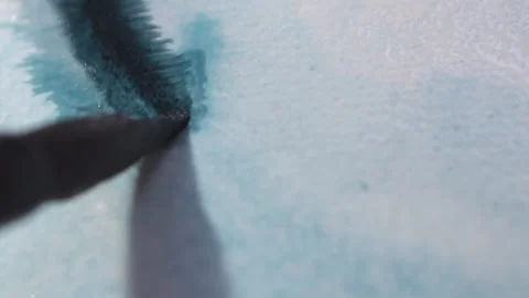 The ink from a blue marker melts onto the Stock Footage 143453315