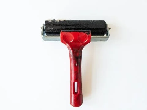 An ink roller for printmaking with a red handle isolated on a white backgroun Photos