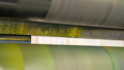 Ink rollers at high speed in a printing factory printing newspapers Stock Footage 121808862