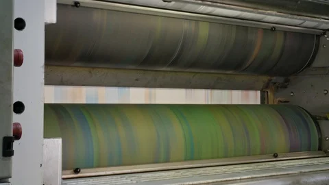 Ink rollers at high speed in a printing factory printing newspapers Stock Footage 121808866