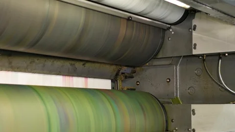 Ink rollers at high speed in a printing factory printing newspapers Stock Footage 121808964