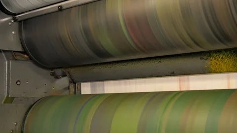 Ink rollers at high speed in a printing factory printing newspapers Stock Footage 121809434