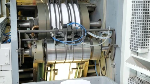 Ink rollers rotate and bring color to envelopes in a factory assembly line Stock Footage 72669844
