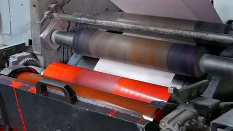Ink rollers rotate and bring color to envelopes in a factory assembly line Stock Footage 72669917