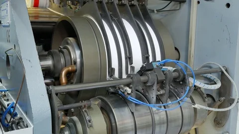 Ink rollers rotate and bring color to envelopes in a factory assembly line Stock Footage 72670041