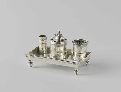 . Ink set standing on a rectangular leaf, with raised edge and four profil... Stock Photos