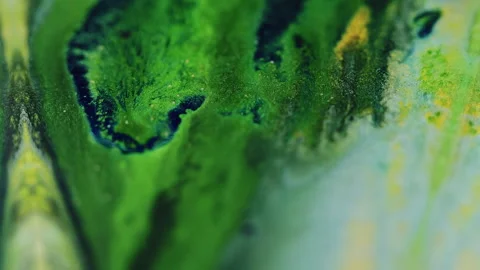 Ink spill glitter fluid drip green black paint mix Stock Footage 274692026