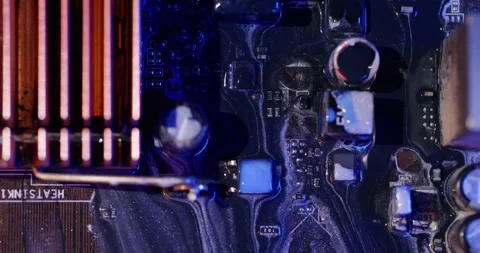 Ink spill processor chip motherboard glitter neon Stock Footage 318529088
