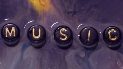 Ink text color fluid spill glitter music letters Stock Footage 341540735