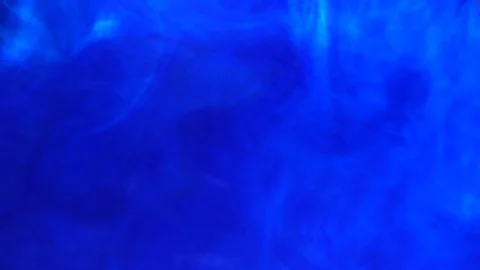 Ink in water. Colour ink reacting in water creating abstract cloud formations Stock Footage