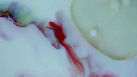 Ink white balls slowly floating in colorful ink liquid. Paint bubbles video. Stockbeeldmateriaal 123282264