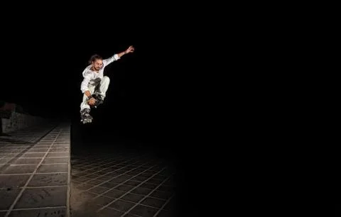Inline rider jumps a short wall Stock Photos