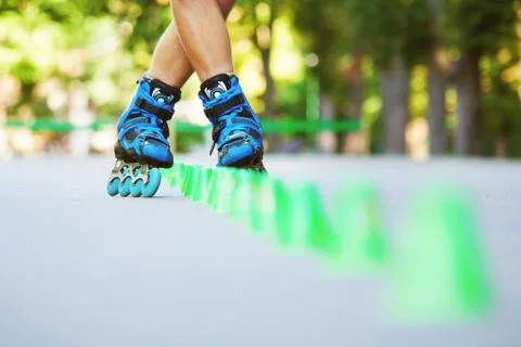 Inline roller skater on a slalom course Stock Photos