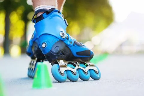 Inline roller skater on a slalom course Stock Photos