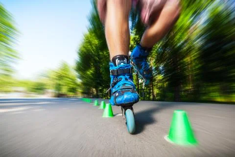 Inline roller skater on a slalom course Stock Photos
