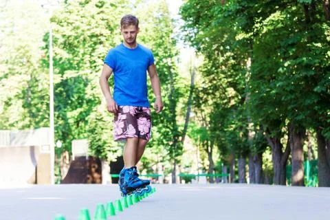 Inline roller skater on a slalom course Stock Photos