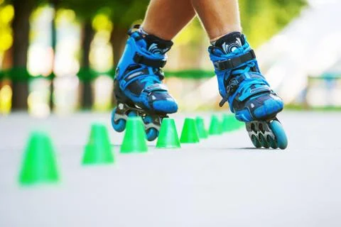 Inline roller skater on a slalom course Stock Photos