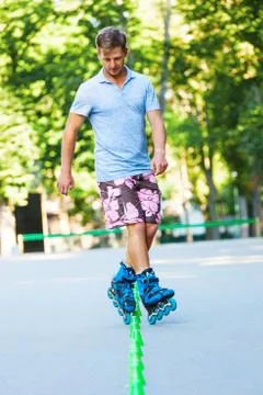 Inline roller skater on a slalom course Stock Photos