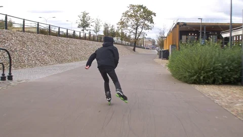 Inline Skater in black enjoying recreation fitness skating on promenade Stock Footage 120445622