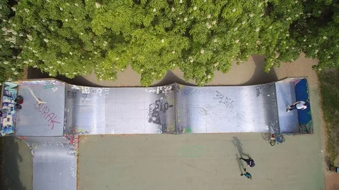 Inline skater does tricks ina  half pipe Stock Footage 107614084
