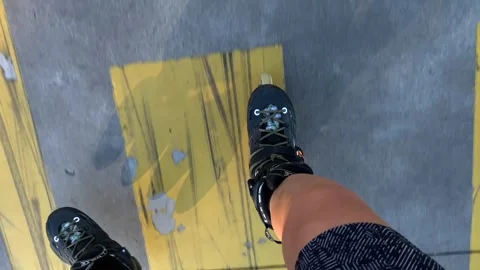 Inline skater gliding, top-down view over pavement with long shadow Stock Footage 345361749