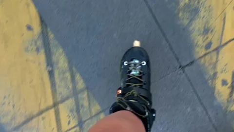 Inline skater rolling POV shot over paved city surface Stock Footage 345361730