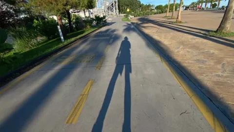 Inline skater rolling POV shot along a seaside cycle lane Stock Footage 345361748