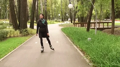 Inline skates. Dark-haired stylish woman moving on roller skates. Slow motion HD 库存影片 71373709