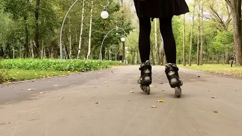 Inline skates. Dark-haired stylish woman moving on roller skates. Slow motion HD Video stock 71375926