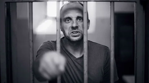 Inmate cursing behind the bars Stock-Footage 32240979