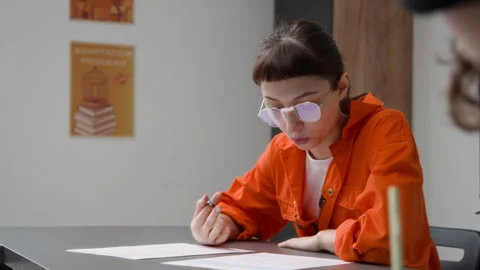Inmate Doing Tasks during Class in Prison and Twirling Pencil in Hand Thinking Stock Footage 328985718