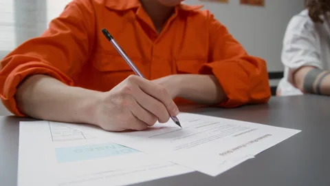 Inmate Doing Tasks with Hand Writing on Paper during Class in Prison Stock Footage 328987413