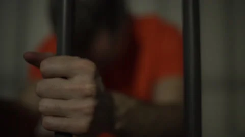 An inmate in prison hold tightly onto bars Stock Footage 59762699