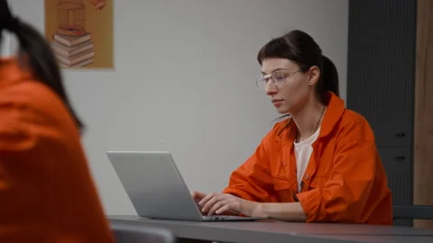 Inmate Using Laptop at Desk during Computer Class in Prison Stock Footage 328998739