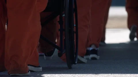Inmates walking in single file line at a female correctional facility Stock Footage 331602995
