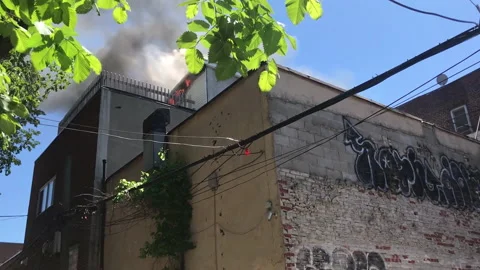 Inner city rooftop fire smoke Stock Footage 169374930