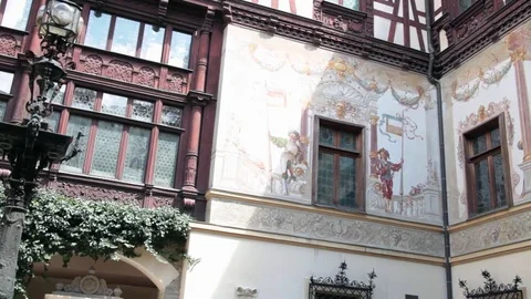 Inner courtyard of Neo-Renaissance castle with ornate timber framing and murals Stock Footage 70573757
