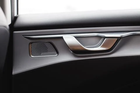 Inner door handle with lock unlock buttons, modern black car interior detail Stock Photos