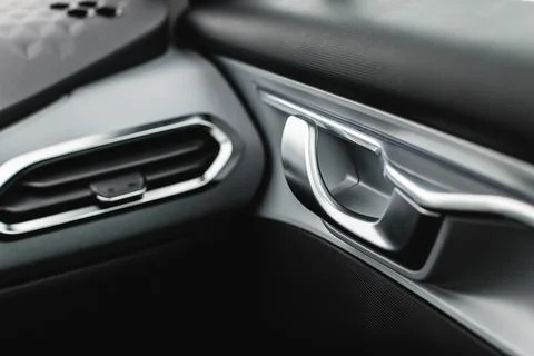 Inner door handle with lock unlock buttons, modern black car interior detail Stock Photos