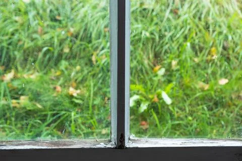 The inner frame of an old window with cracked, peeling white paint, cobwebs,  Stock Photos