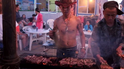 An Inner Mongolian man crying his roast mutton for sale Stock Footage 40391294