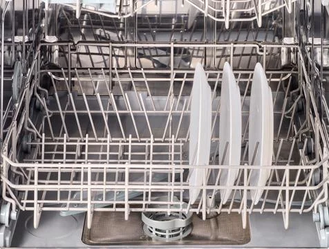 Inner space of dishwasher machine. Stock Photos