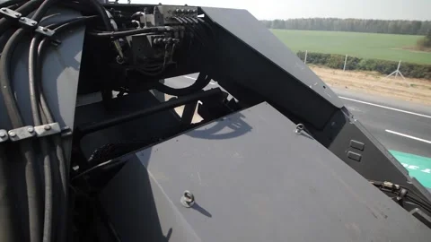 Inner space of road paving machine with hot asphalt on conveyor Stock Footage 158040898
