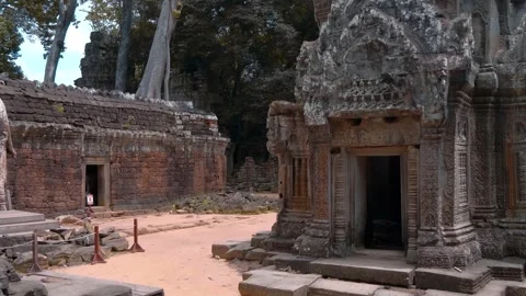 Inner yard of the ancient Ta Prohm Temple with its stone carved walls  Stock Footage 318678843