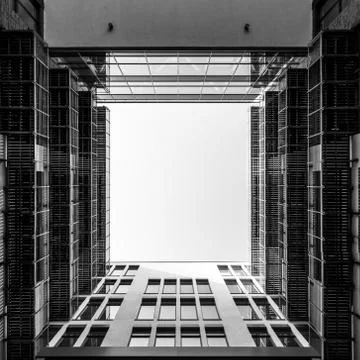 Inner yard of modern office building looking upwards through square opening i Stock Photos