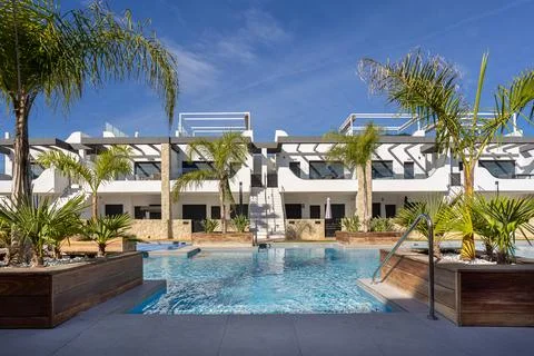 Innova Beach Punta Prima poolside view with tropical plants and modern whit.. Stock Photos