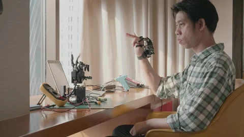 Innovating Robotics: A Young Engineer at Work Stock Footage 319415139
